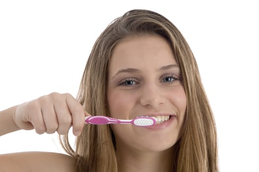 charming woman brushing her teeth with white background