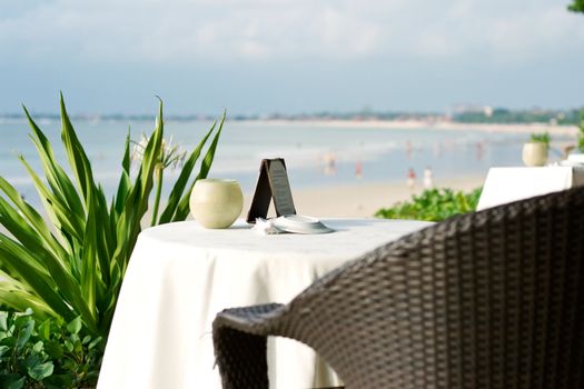 table and chair on a beach, shallow DOF