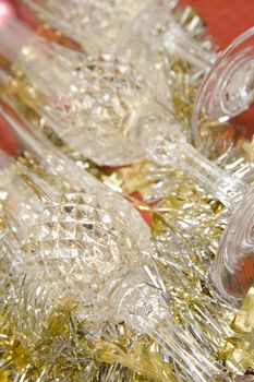 Three glasses with Christmas decoration on red background.