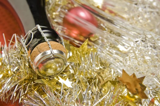 Three glasses with wine bottle and Christmas decoration on red background.