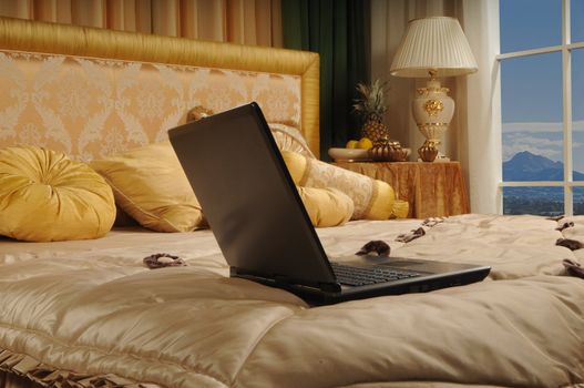 notebook on a luxurious bed in a hotel