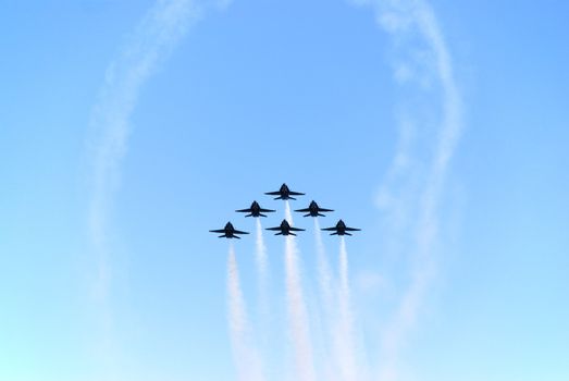 a formation of airplanes on a blue sky