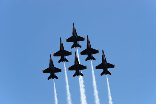 a formation of airplanes on a blue sky 