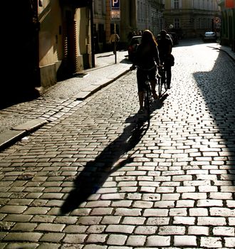 Silhouette of a people riding  by bycicle. Prague. Czech Republic