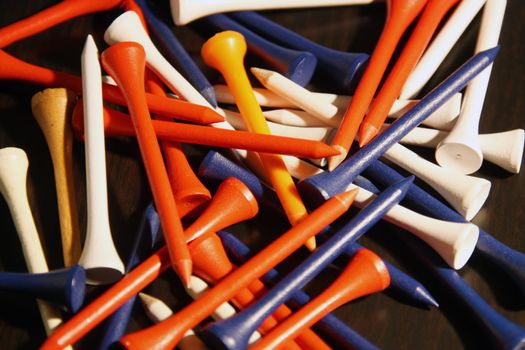 Colored golf tees in a pile 