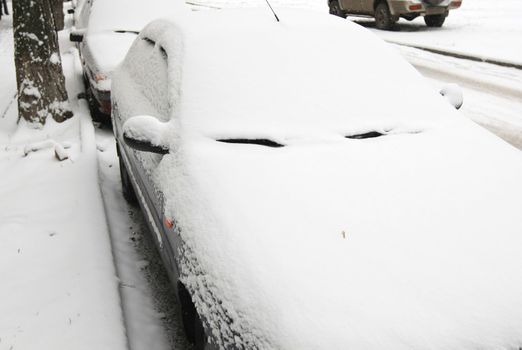 Snow-covered car in the city