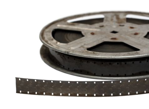 old movie film on metal reel close-up isolated on white
