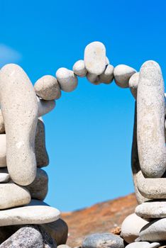 Arch from a sea pebble on a beach in the summer