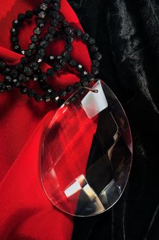 Glass ornament against a red and black velvet