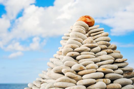 Pyramid from a pebble on seacoast in the summer