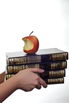 books and apple on white