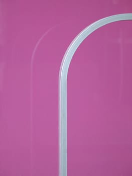 silver railing against pink wall