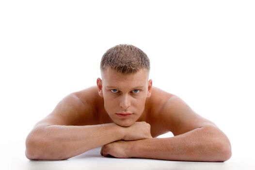 laying muscular male looking at you on an isolated white background