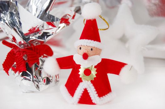 Santa claus toy with present on white