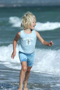 Little girl running on the beach