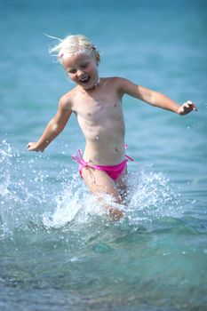 Little girl running on the beach