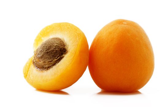 one apricot and a half on white background