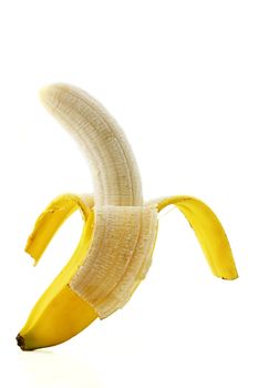 one peeled standing banana on white background