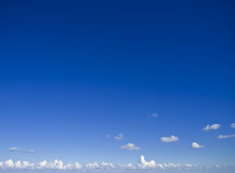 Slight cloud over a clear blue sky ideal as backdrop