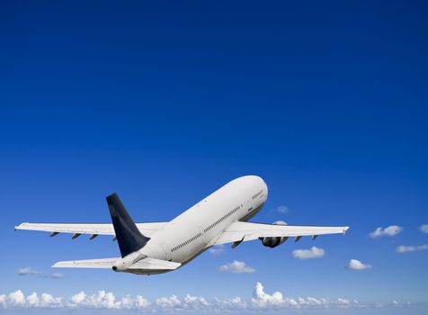 Civil airliner over a deep blue sky with some cloud