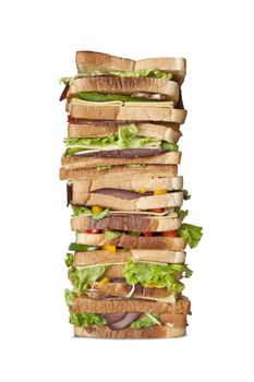 Big 16 layered sandwich with a variety of meats and veggies isolated on white background