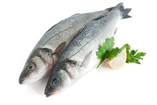 two sea bass with lemon and parsley isolated on white background with clipping path
