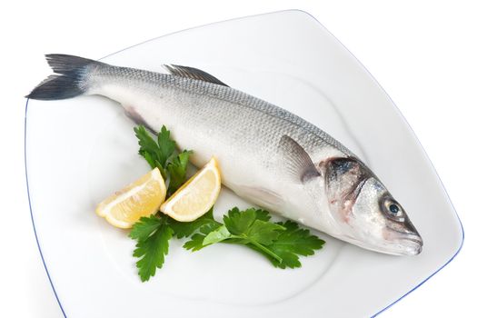 plate with sea bass, lemon and parsley isolated on white background with clipping path