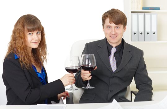 Young clerks drink wine in the office - celebrate