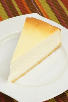 Slice of cheesecake on a kitchen plate