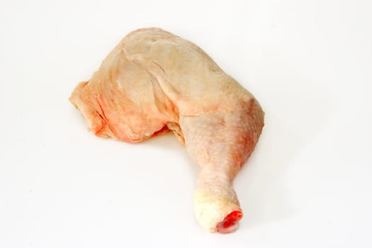 Raw chicken leg  on bright background