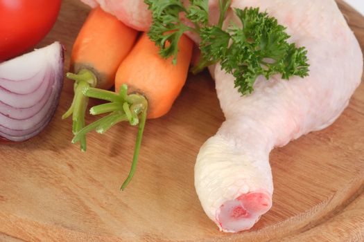 Raw chicken leg in detal on brown background