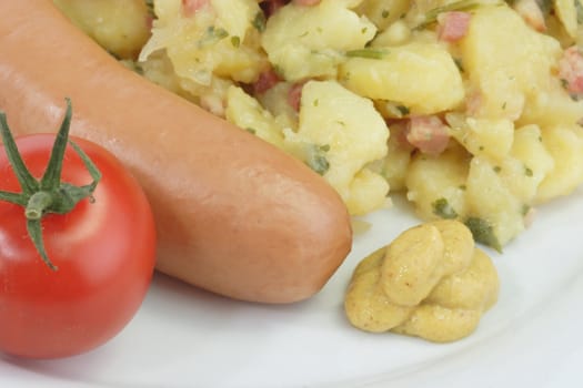 Crisp cooked sausage with potato salad on bright background