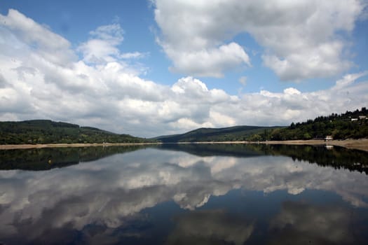 Landscape with ake with cloudy sky