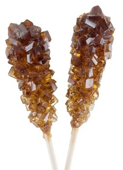 Wooden sticks with crystal sugar on the white background