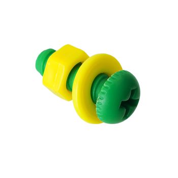Green plastic bolt and yellow nut on the white background