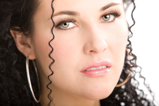 Gentle face of a young woman with curly hair