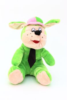 Green child toy dog of plush with tie, isolated