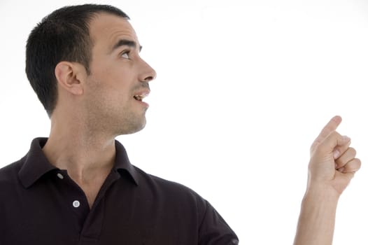 smart pose of young guy pointing against white background