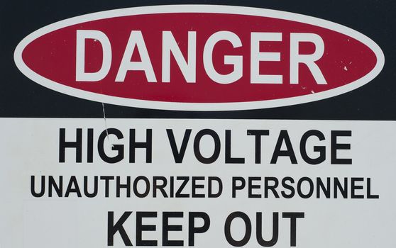 a sign stating of a high voltage danger and to keep out