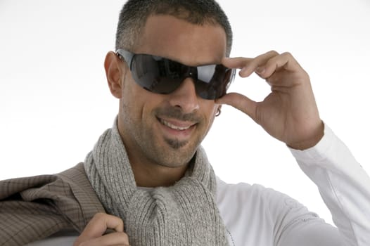 handsome male holding eyewear against white background