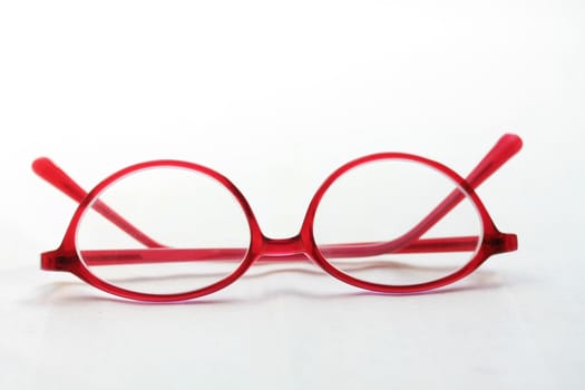 A pair of glasses, red pink plastic, presription glasses