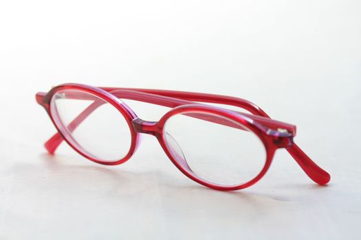 A pair of glasses, red pink plastic, presription glasses