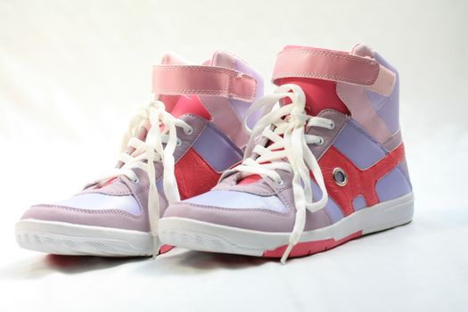 A pair of fashionable sneakers, pink and lila