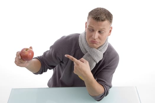 young male pointing the apple on an isolated background