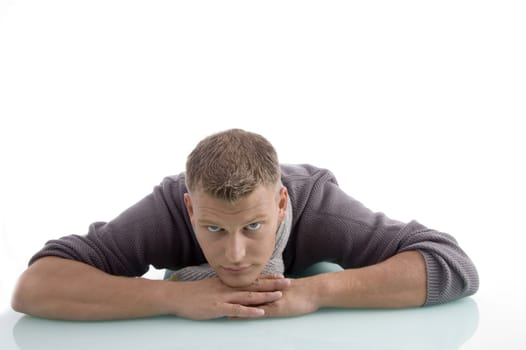 laying adult male looking at camera on an isolated background