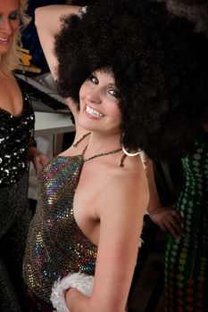 Pretty girl with afro wig at a 1970s Disco Music Party