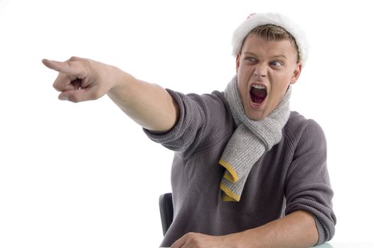 shouting male with christmas hat pointing aside on an isolated white background