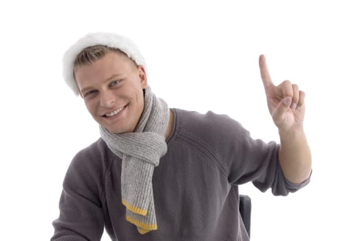 smiling young male with christmas hat indicating upside on an isolated background
