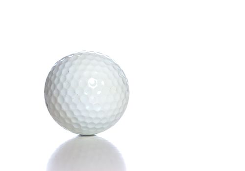 A white golf ball with a reflection, shot against a white background.