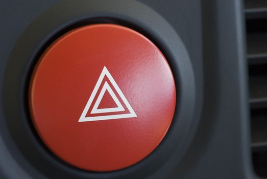 a large red hazard warning light button